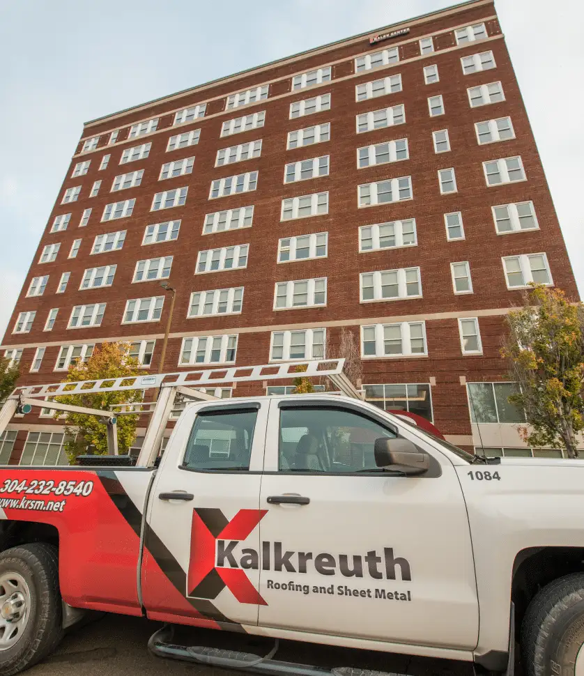 Low-angle view of a tall brick high-rise building labeled 